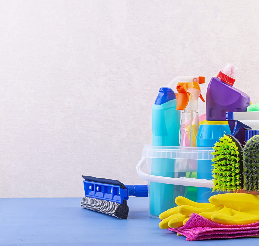 Cleaning service concept. Colorful cleaning set for different surfaces in kitchen, bathroom and other rooms.